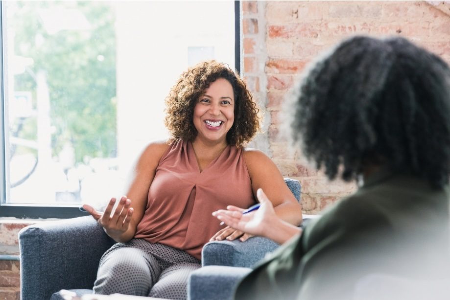 Close-up of a life coach using powerful questioning techniques in a professional session.
